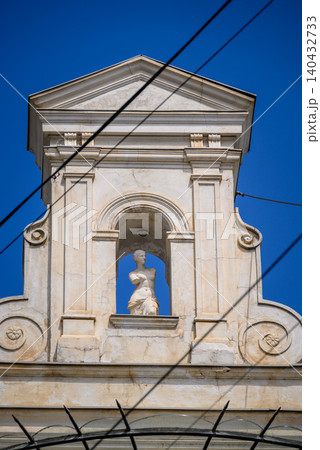Historic facade with statue under blue sky Historic facade with statue under blue sky 140432733