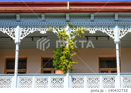 Traditional house veranda with ornate white woodwork Traditional house veranda with ornate white woodwork 140432738