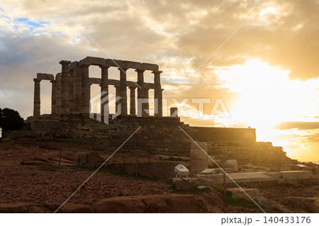 Greece Cape Sounio. Ruins of an ancient temple of Poseidon, Greek god of the sea, on sunset.Tourist landmark of Attica, Sounion, Greece Greece Cape Sounio. Ruins of an ancient temple of Poseidon, Greek god of the sea, on sunset.Tourist landmark of Attica, Sounion, Greece 140433176