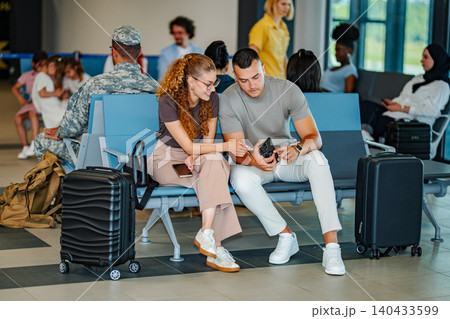 Couple looking at smartphone waiting in airport terminal 140433599
