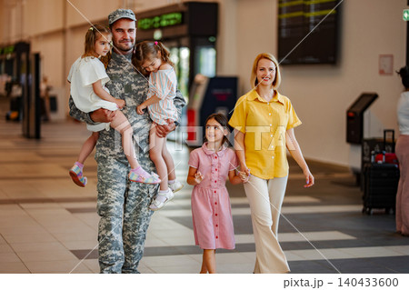 Military dad reuniting with family at airport after deployment Military dad reuniting with family at airport after deployment 140433600