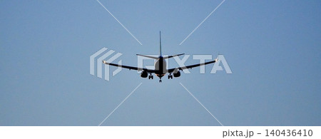 長旅を終え空港に着陸体勢に入る飛行機の後ろ姿のシンプルな風景 長旅を終え空港に着陸体勢に入る飛行機の後ろ姿のシンプルな風景 140436410