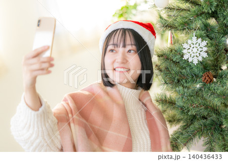 クリスマスツリーの飾り付けをする女性 クリスマスツリーの飾り付けをする女性 140436433
