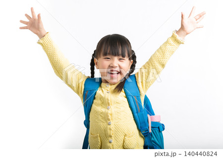 Excited Asian schoolgirl raising arms in celebration, back to school success concept. Excited Asian schoolgirl raising arms in celebration, back to school success concept. 140440824