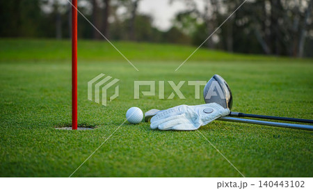 Golf balls on a green lawn in a beautiful golf course with morning sunshine. Golf balls on a green lawn in a beautiful golf course with morning sunshine. 140443102