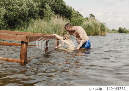 dynamic, relaxed shot boy jumping into natural lake. child is captured mid flight, creating sense excitement. image perfect family vacations, water safety, promoting active lifestyle among children dynamic, relaxed shot boy jumping into natural lake. child is captured mid flight, creating sense excitement. image perfect family vacations, water safety, promoting active lifestyle among children 140443781