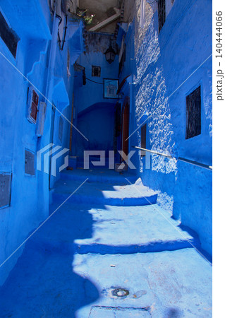 A narrow pedestrian street displays its bright blue painted walls in the medina of Chefchaouen, Morocco A narrow pedestrian street displays its bright blue painted walls in the medina of Chefchaouen, Morocco 140444066