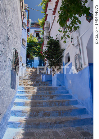 A narrow pedestrian street displays its bright blue painted walls in the medina of Chefchaouen, Morocco A narrow pedestrian street displays its bright blue painted walls in the medina of Chefchaouen, Morocco 140444075