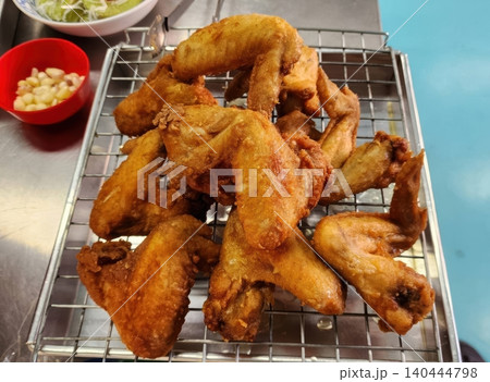 Golden Crispy Deep Fried Chicken Wings on a Cooling Rack Street Food 140444798