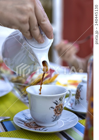 pours coffee pours coffee 140445130