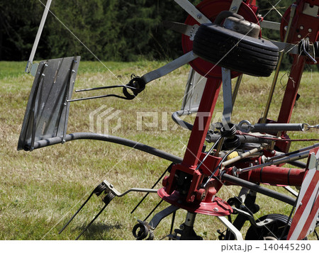 Red Hay Tedder Farm Machinery Closeup On Grass Field Agricultural Equipment For Haymaking 140445290
