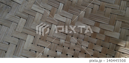 Traditional woven bamboo surface featuring a classic basket weave pattern. Traditional woven bamboo surface featuring a classic basket weave pattern. 140445508