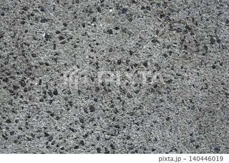 Rough stone aggregate plaster on a building wall texture 140446019