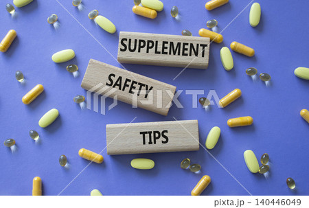 SUPPLEMENT SAFETY TIPS symbol. Concept words SUPPLEMENT SAFETY TIPS on wooden blocks. Beautiful purple background with pills. Healthcare and SUPPLEMENT SAFETY TIPS concept. Copy space. SUPPLEMENT SAFETY TIPS symbol. Concept words SUPPLEMENT SAFETY TIPS on wooden blocks. Beautiful purple background with pills. Healthcare and SUPPLEMENT SAFETY TIPS concept. Copy space. 140446049