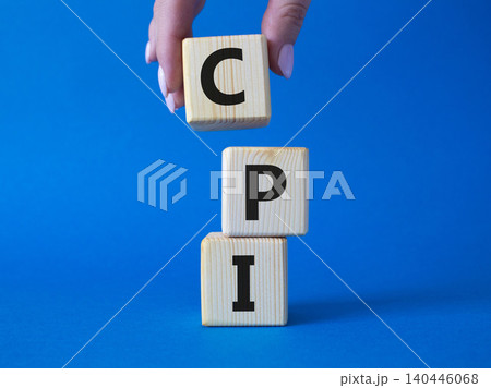 CPI - Consumer Price Index symbol. Concept word CPI on wooden cubes. Businessman hand. Beautiful blue background. Business and CPI concept. Copy space. CPI - Consumer Price Index symbol. Concept word CPI on wooden cubes. Businessman hand. Beautiful blue background. Business and CPI concept. Copy space. 140446068