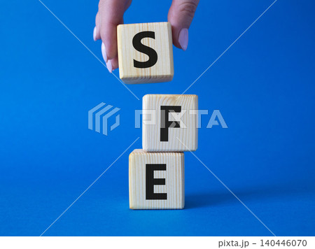 SFE - Sales Force Effectiveness. Wooden cubes with word SFE. Businessman hand. Beautiful blue background. Business and Sales Force Effectiveness concept. Copy space. SFE - Sales Force Effectiveness. Wooden cubes with word SFE. Businessman hand. Beautiful blue background. Business and Sales Force Effectiveness concept. Copy space. 140446070