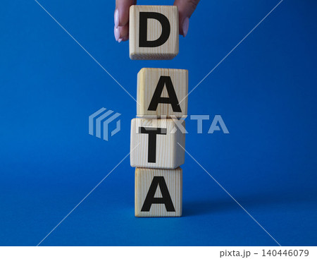 Data symbol. Concept word Data on wooden cubes. Businessman hand. Beautiful blue background. Business and Data concept. Copy space. 140446079