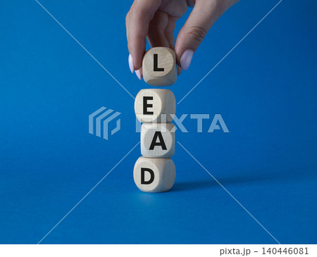 Lead symbol. Concept word Lead on wooden cubes. Businessman hand. Beautiful blue background. Business and Lead concept. Copy space. Lead symbol. Concept word Lead on wooden cubes. Businessman hand. Beautiful blue background. Business and Lead concept. Copy space. 140446081