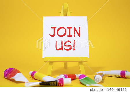 Join us symbol. Concept word Join us on wooden blocks. Beautiful yellow background with paints and easel. Business and Join us concept. Copy space Join us symbol. Concept word Join us on wooden blocks. Beautiful yellow background with paints and easel. Business and Join us concept. Copy space 140446123