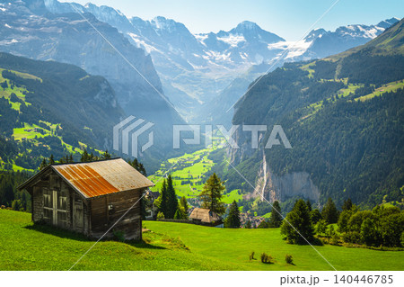 Wooden huts on the alpine slope slope, Lauterbrunnen valley, Switzerland Wooden huts on the alpine slope slope, Lauterbrunnen valley, Switzerland 140446785