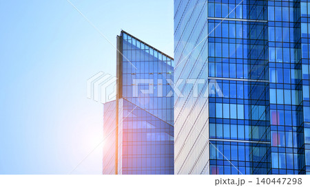 Modern office building with glass facade on a clear sky background. Transparent glass wall of office building. 140447298