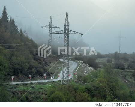 a tall, angular lattice steel structure designed to carry electrical power lines over long distances a tall, angular lattice steel structure designed to carry electrical power lines over long distances 140447702