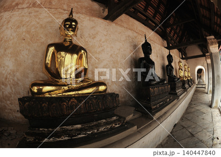 The ancient Buddha images are lined up in the cloister on a Church of Wat Khanon, which also serves as a venue for traditional Thai shadow puppet shows in Thailand. 140447840