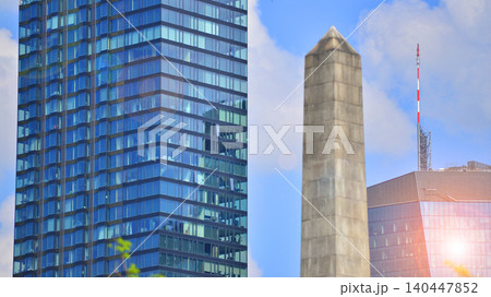 Modern office building with glass facade on a clear sky background. Transparent glass wall of office building. 140447852