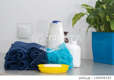 Spa Products Set Rolled Towels, Organic Soap and Essential bottles with shampoo for washing body and hair in the bathroom. Washcloth, lotion and liquid Shower gel 140448193