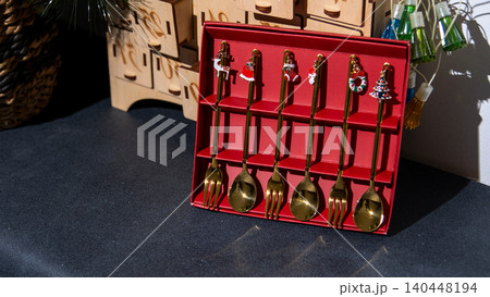 Christmas golden Spoons and Forks tableware cutlery set on black 140448194