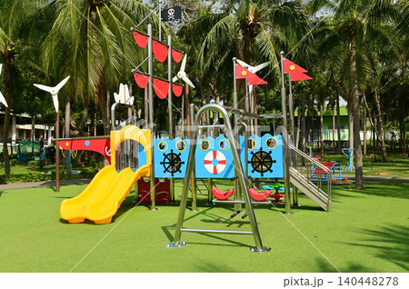 Climbing structures and slides are playground equipment for children, which are part of the public park. Climbing structures and slides are playground equipment for children, which are part of the public park. 140448278