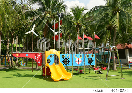 Climbing structures and slides are playground equipment for children, which are part of the public park. Climbing structures and slides are playground equipment for children, which are part of the public park. 140448280