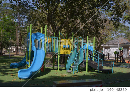 Climbing structures and slides are playground equipment for children, which are part of the public park. Climbing structures and slides are playground equipment for children, which are part of the public park. 140448289