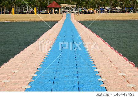 Colorful floating platforms made of plastic stand out in the sea off Ban Amphoe beach, providing a place for tourists to walk and relax, and sometimes even serving as piers. 140448455
