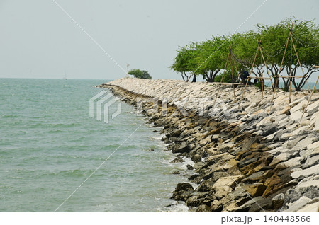 Breakwaters are made by placing large stones in a line. 140448566