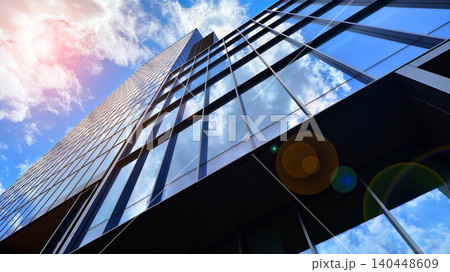 View of modern office building with many windows against clear sky. Glass facade wall. View of modern office building with many windows against clear sky. Glass facade wall. 140448609
