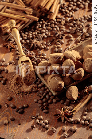 Chocolate truffles and a wooden spoon with cacao powder. Chocolate truffles and a wooden spoon with cacao powder. 140448691