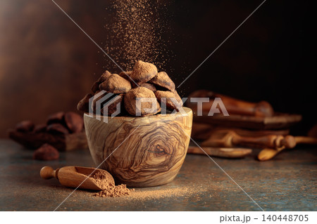 Chocolate truffles in wooden dish are sprinkled with cocoa powder. Chocolate truffles in wooden dish are sprinkled with cocoa powder. 140448705
