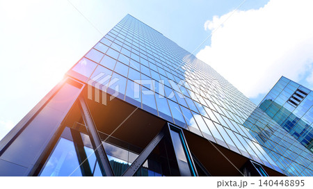 Steel and glass. The subject of modern architecture or construction industry. Modern office building facade with tall steel construction elements and full height windows between. 140448895