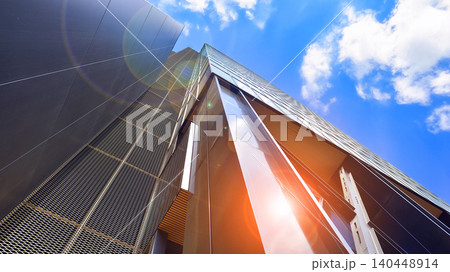 Steel and glass. The subject of modern architecture or construction industry. Modern office building facade with tall steel construction elements and full height windows between. Steel and glass. The subject of modern architecture or construction industry. Modern office building facade with tall steel construction elements and full height windows between. 140448914