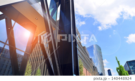 Steel and glass. The subject of modern architecture or construction industry. Modern office building facade with tall steel construction elements and full height windows between. 140448924