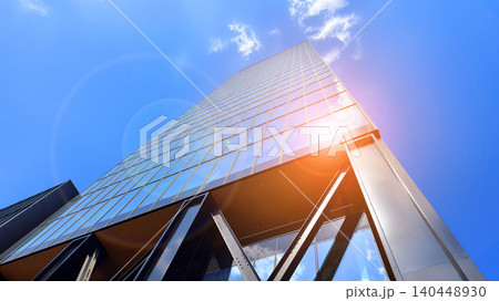 Steel and glass. The subject of modern architecture or construction industry. Modern office building facade with tall steel construction elements and full height windows between. Steel and glass. The subject of modern architecture or construction industry. Modern office building facade with tall steel construction elements and full height windows between. 140448930