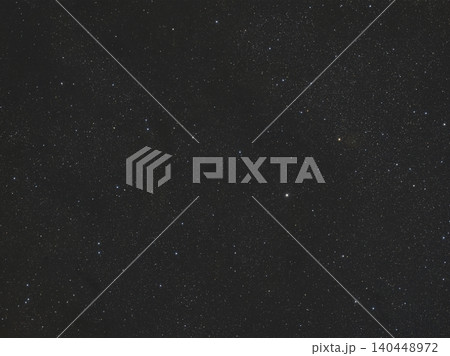 Vast dark night sky is visible, densely packed with myriad white and subtly colored stars. This cosmic view showcases celestial bodies in the depths of space at night. Vast dark night sky is visible, densely packed with myriad white and subtly colored stars. This cosmic view showcases celestial bodies in the depths of space at night. 140448972