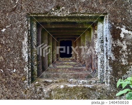 Mossy concrete ventilation shaft with nested square openings 140450010