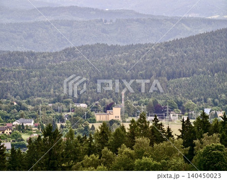 Small village and industrial building nestled in forested valley Small village and industrial building nestled in forested valley 140450023