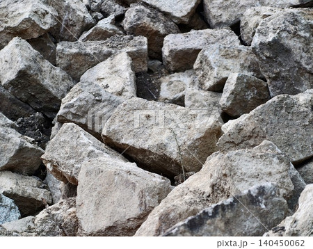 Pile of irregular limestone rocks on natural ground Pile of irregular limestone rocks on natural ground 140450062
