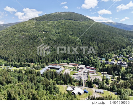 Mountain resort town nestled at the edge of a dense pine forest Mountain resort town nestled at the edge of a dense pine forest 140450096