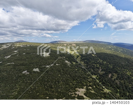 Rolling green mountain ridge under partly cloudy sky Rolling green mountain ridge under partly cloudy sky 140450103