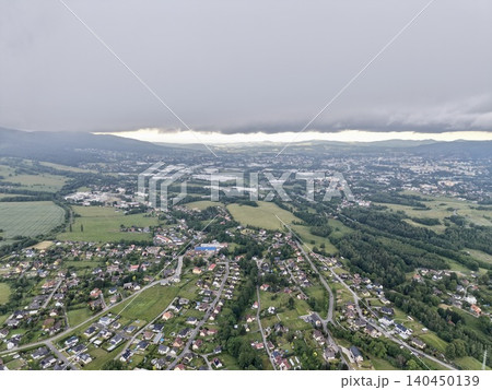 Aerial view of countryside town under heavy cloud cover Aerial view of countryside town under heavy cloud cover 140450139