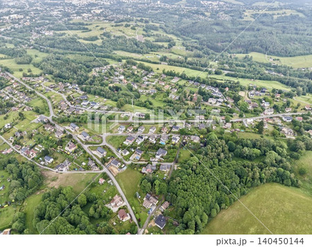 Aerial view of a rural residential village surrounded by forests and fields Aerial view of a rural residential village surrounded by forests and fields 140450144